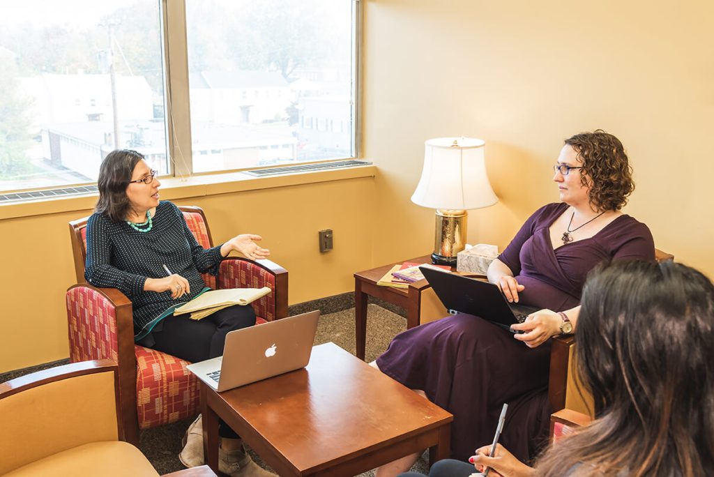 women seated and talking